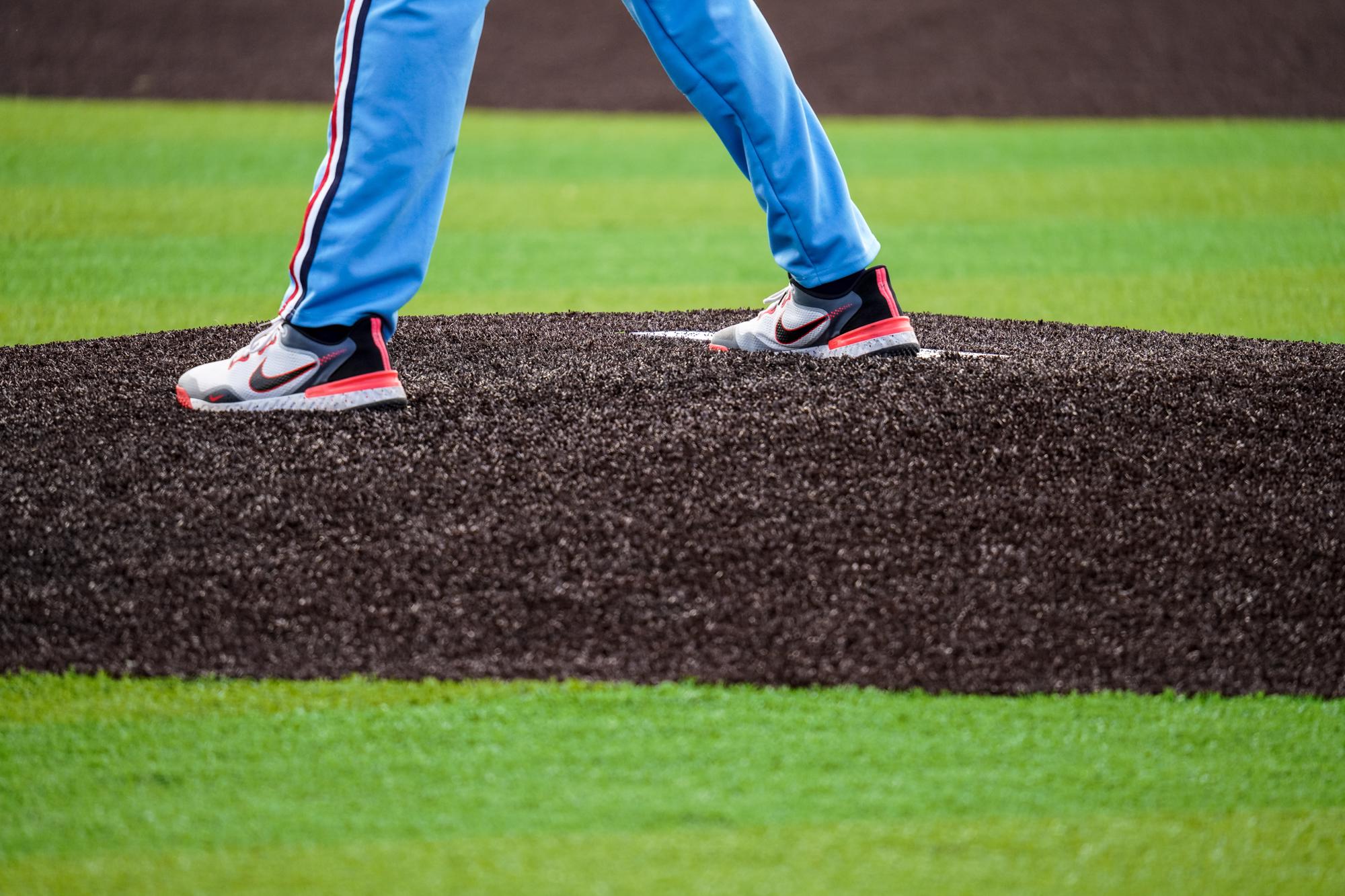 Baseball player standing on turf. 