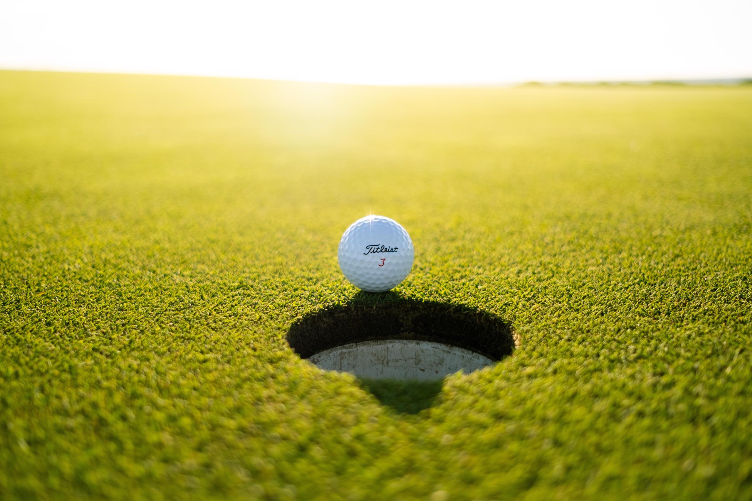 Golf ball right near hole